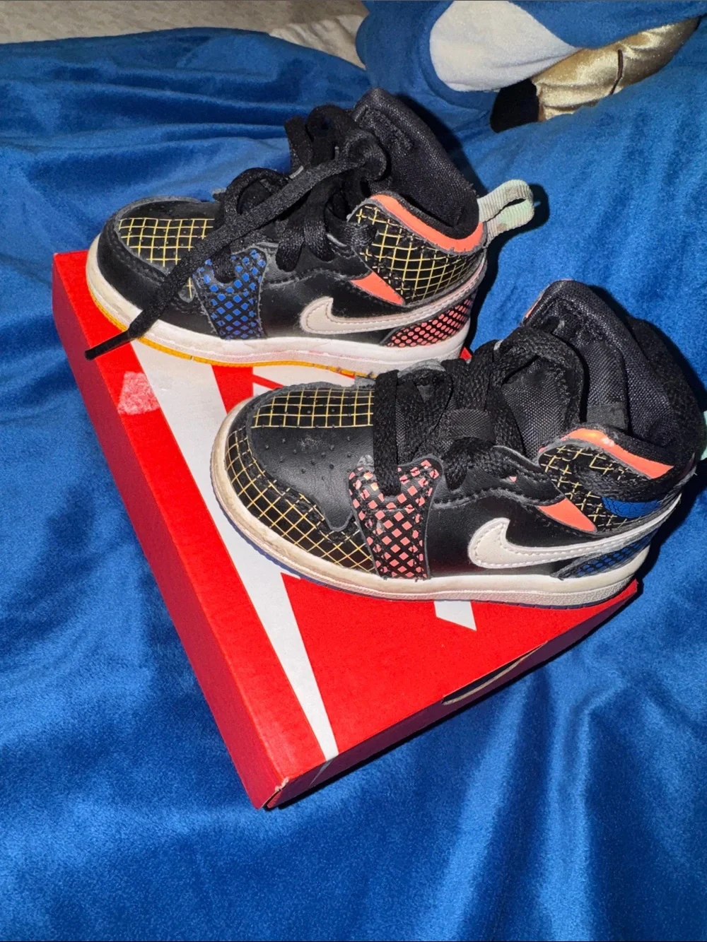 Nike Kids Black Sneakers with Blue and Orange Accents